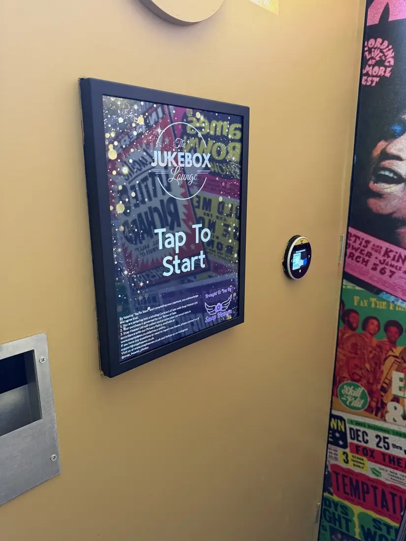The Jukebox Lounge photobooth touchscreen and payment point inside a yellow booth