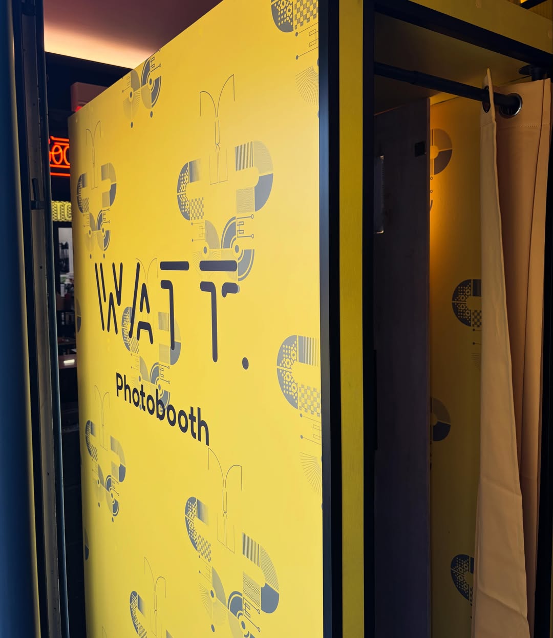 Watt Bar branded yellow photobooth exterior