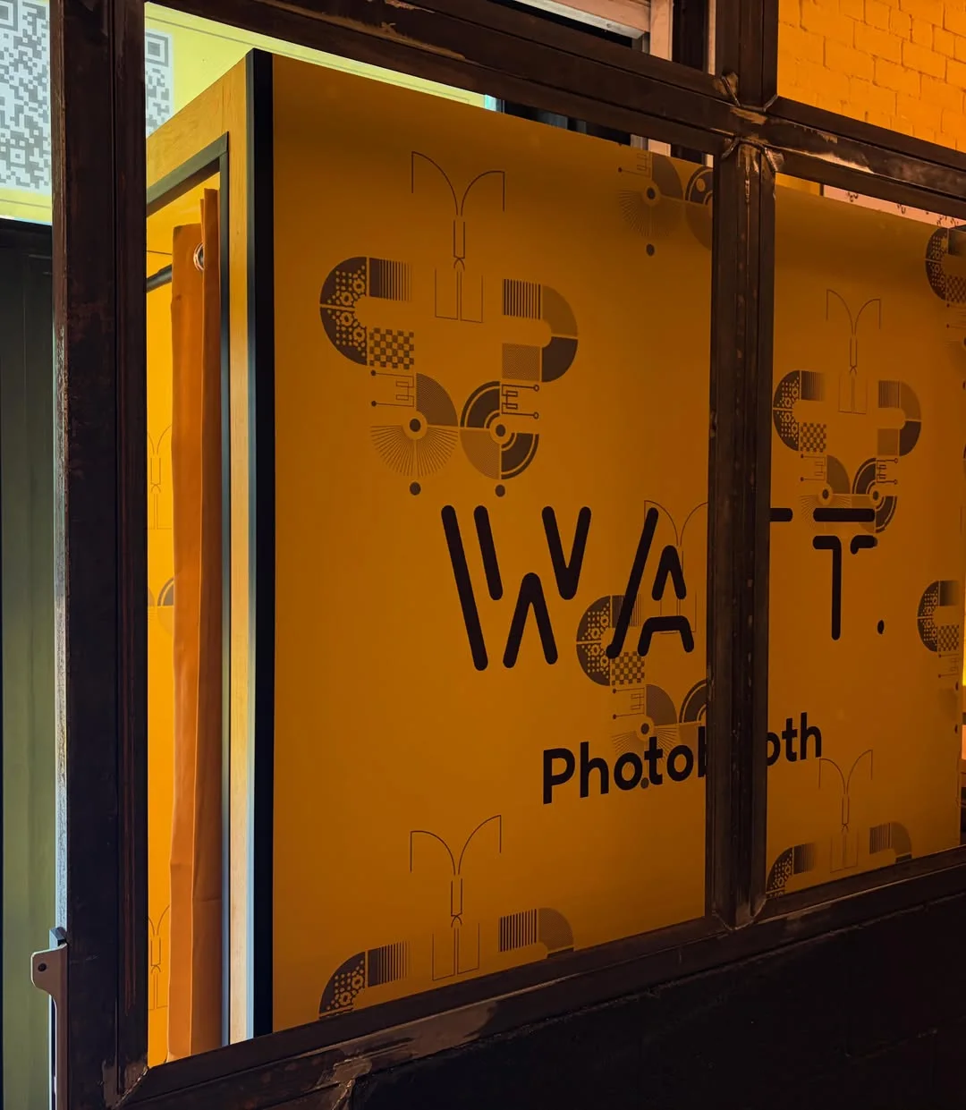 Right side of the bold yellow Watt Bar photobooth installation